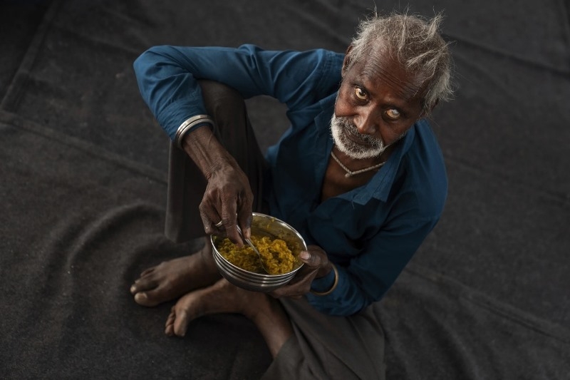 an-elderly-indian-man-taking-food-7273f7c8b1fea0f02468da3f7ad59fd51722707732.jpg