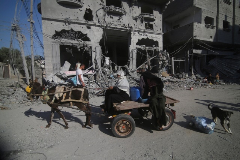 palestinian-families-leaving-homes-devastated-by-israeli-raids-412c70776cb286378339a5efa8bba1641741369870.jpg