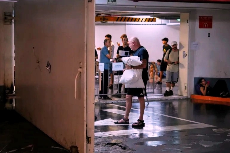 israelis-take-shelter-in-a-parking-garage-during-a-missile-alert-from-iran-in-tel-aviv-israel-early-on-tuesday-baz-ratner-ap_11zon-89c8d0ffa66627bc332e71c89db3fc811750140997.jpg