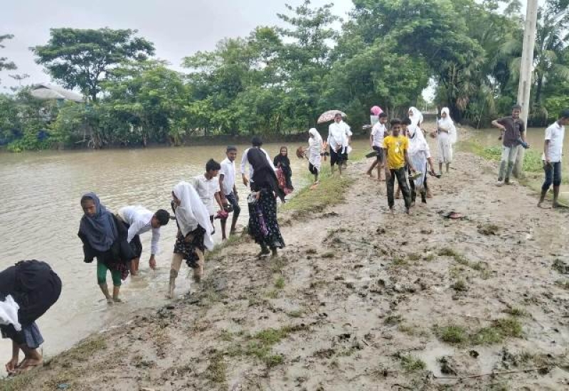primary-school-students-walking-through-a-muddy-road-in-kalapara-c15e7b43a0610418fecb1969dd452c6a1757184284.jpg