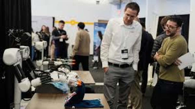 people-watch-as-a-robot-made-by-weave-robotics-folds-clothes-during-the-humanoids-summit-thursday-dec-ecea2649aac2a61d7ae5c431e951d7ea1765686734.jpg