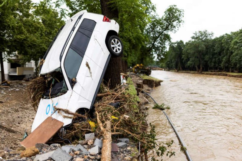 a-car-washed-up-by-the-flood-leans-against-a-tree-while-the-river-ahr-can-be-seen-in-the-background-in-bad-neuenahr-germany-friday-july-16-2021-ccfd18055be6438c9f317fa5883214c31626512922.jpg