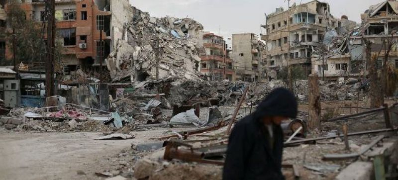 conflicts-a-man-walks-in-front-of-destroyed-buildings-in-harasta-syria-a5a1661d8249ff49a6f25c792e80fc741645892076.jpg