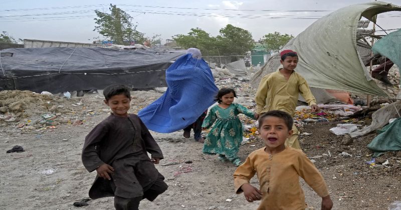 afghanistan-a-woman-wearing-a-burka-and-her-children-walk-in-front-of-their-house-in-kabul-afghanistan-sunday-may-8-2022-02799b235cc5dc441e7c872cddb81db31652417683.jpg