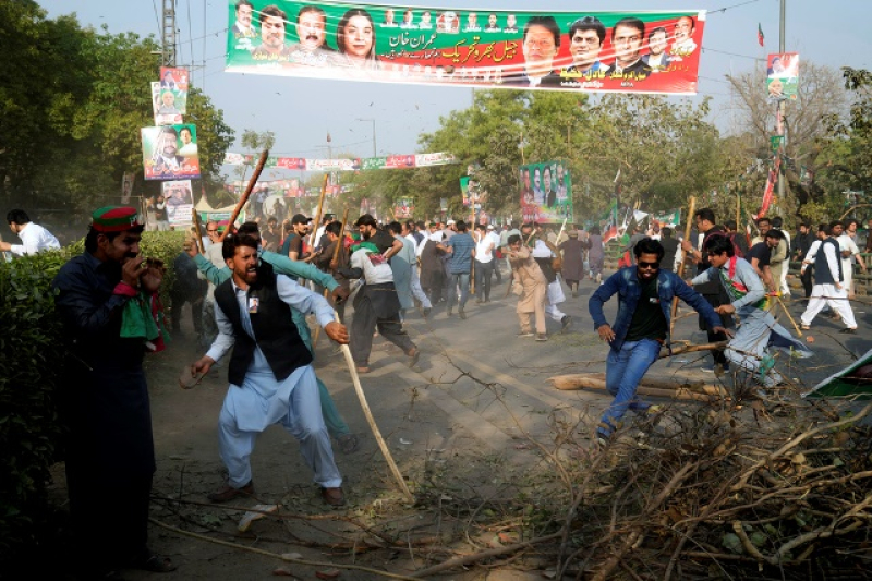 supporters-of-former-prime-minister-imran-khan-throw-stones-toward-riot-police-officers-during-clashes-outside-his-residence-in-lahore-pakistan-tuesday-march-14-2023-9f5ed4c223c3a521440f27cb5112573c1678862335.jpg