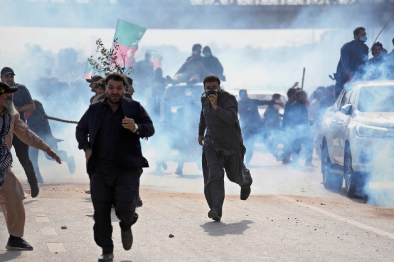 supporters-of-former-prime-minister-imran-khan-run-for-cover-after-police-fire-tear-gas-shell-to-disperse-them-during-clashes-in-islamabad-pakistan-saturday-march-18-2023-e638149067971580788a52318bdf0b791679209142.jpg
