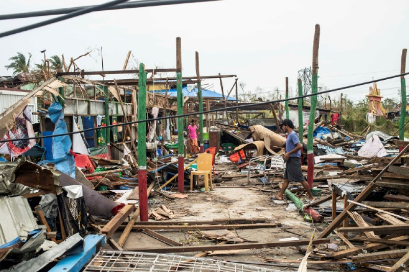local-residents-walk-past-damaged-buildings-after-cyclone-mocha-in-sittwe-township-rakhine-state-myanmar-tuesday-may-16-2023-edd2780fc41095e8d0aab80153fc42ae1684472513.jpg