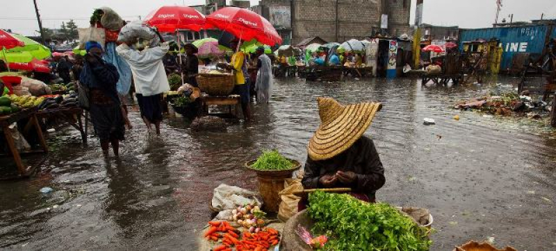 a-woman-sells-produce-at-a-flooded-market-place-in-haiti-6adb1ce1c1c98367c081983ae71d61821701541887.jpg