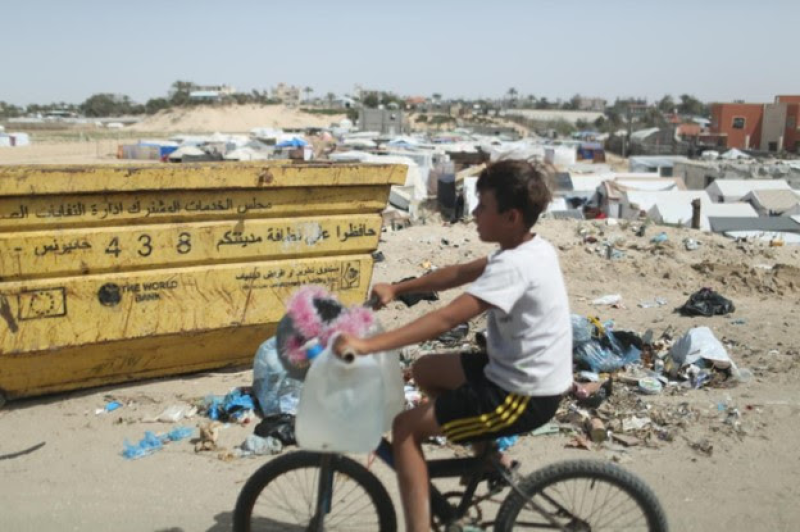 a-palestinian-boy-carries-drinking-water-in-jars-7a96d7c2f9454264aca72c2ce8548a3e1714240145.png