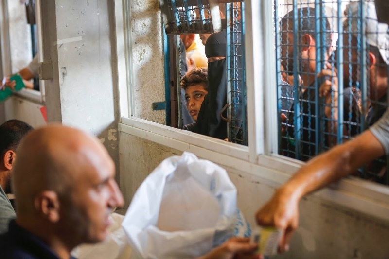 unrwa-teams-distribute-food-aid-to-forcibly-displaced-families-in-an-unrwa-school-turned-shelter-in-deir-al-balah-82ef282eada8a61142c764984711c5311726681522.jpg