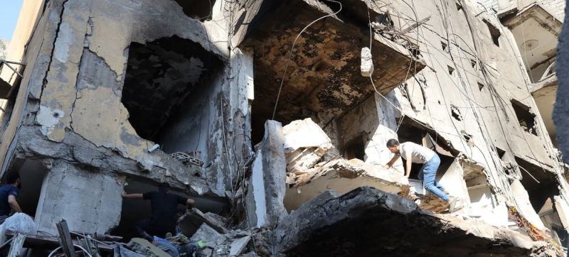 a-man-climbs-over-a-destroyed-building-in-the-southern-suburbs-of-beirut-lebanon-318351fa98fdc118cfe1d958b983e7b61728022162.jpg