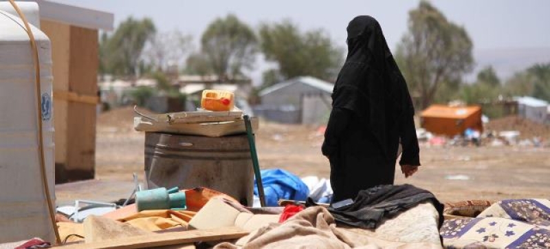 a-woman-in-yemen-walks-through-an-area-devastated-by-floods-e0541fc2087d06ba89f43c572657a0341729013185.jpg