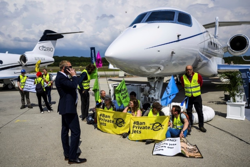 environmental-activists-demonstrate-while-handcuffing-themselves-to-a-plane-during-the-european-business-aviation-convention-and-exhibition-ebace-at-the-geneve-aeroport-in-geneva-switzerland-may-23-2023-8a5f0ae7baf589c957aac33925bf57dd1736271532.jpg