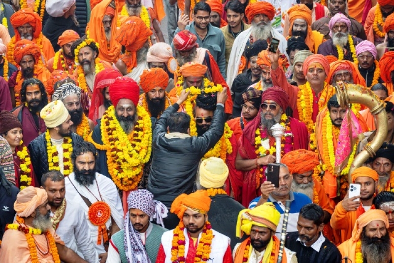 a-devotee-garlands-a-senior-hindu-holy-man-walking-in-a-procession-a-day-before-the-45-day-long-maha-kumbh-festival-in-prayagraj-india-sunday-jan-11923e7bad58c9367b40b76126fa18e71736735739.jpg