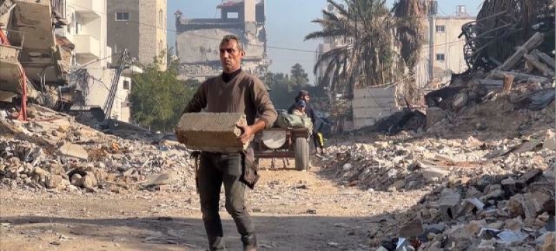 a-man-removes-debris-in-gaza-af2f612272818f72cce3ca87702bc5e61739470233.jpg